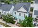 Aerial view of a light blue two-story home surrounded by lush trees and neighboring houses at 1661 Indy Dr, North Charleston, SC 29405