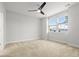 Bright bedroom with neutral carpet, ceiling fan, and large windows for ample natural light and comfort at 1661 Indy Dr, North Charleston, SC 29405