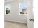 Bright bedroom featuring neutral carpeting, white walls, and two large windows with horizontal blinds at 1661 Indy Dr, North Charleston, SC 29405