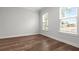 Bright bedroom with hardwood floors and two windows providing plenty of natural light at 1661 Indy Dr, North Charleston, SC 29405