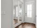 Bright entryway with hardwood floors, glass panel door, and white trim at 1661 Indy Dr, North Charleston, SC 29405
