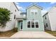 Charming two-story home with light blue siding, white trim, and a cozy front porch at 1661 Indy Dr, North Charleston, SC 29405