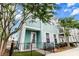 Charming two-story home featuring a quaint porch, black metal fencing, and an inviting, well-maintained yard at 1661 Indy Dr, North Charleston, SC 29405