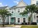 Two-story home with blue siding and white trim, complemented by mature trees and manicured landscaping at 1661 Indy Dr, North Charleston, SC 29405