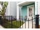 Inviting front porch showcasing artificial lawn and space for outdoor seating with decorative columns and black metal fence at 1661 Indy Dr, North Charleston, SC 29405