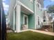 Inviting front porch showcasing an artificial lawn and ample space for outdoor seating with decorative columns at 1661 Indy Dr, North Charleston, SC 29405