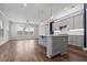 Open kitchen features a center island with bar seating, stylish pendant lighting, and a subway tile backsplash at 1661 Indy Dr, North Charleston, SC 29405
