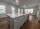 Kitchen island boasts a large sink, stainless steel appliances, a quartz countertop, and cabinet storage underneath at 1661 Indy Dr, North Charleston, SC 29405