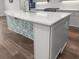 Close-up of the kitchen island featuring a quartz countertop, a stylish faucet, and cabinet storage at 1661 Indy Dr, North Charleston, SC 29405