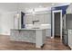 Spacious kitchen with stainless steel appliances, ample cabinet space, and a large center island for prep and dining at 1661 Indy Dr, North Charleston, SC 29405