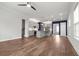 Spacious living room features an open floor plan to the kitchen with gorgeous hardwood floors and abundant natural light at 1661 Indy Dr, North Charleston, SC 29405