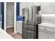 A stainless steel refrigerator complements the kitchen with light colored cabinets and white backsplash at 1661 Indy Dr, North Charleston, SC 29405