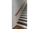 Stylish staircase featuring two-toned steps and a sleek handrail, blending safety with sophistication at 1661 Indy Dr, North Charleston, SC 29405