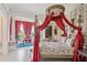 Ornate bedroom featuring a four-poster canopy bed, floral wallpaper, and bright windows at 172 Tradd St, Charleston, SC 29401