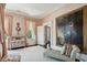 Bedroom featuring a chaise lounge, floral wallpaper, and large painting on the wall at 172 Tradd St, Charleston, SC 29401