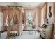 Bedroom featuring a canopy bed, floral accents, and a writing desk with a chair at 172 Tradd St, Charleston, SC 29401