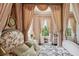 Bedroom featuring a canopy bed, floral accents, and a desk with a chair at 172 Tradd St, Charleston, SC 29401