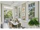 Dining room with checkered floors, bright windows, and adjacent sunroom offering abundant natural light at 172 Tradd St, Charleston, SC 29401