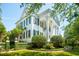 Elegant white home featuring classic architectural details, charming shutters, and manicured greenery at 172 Tradd St, Charleston, SC 29401