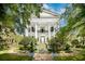 Stately white home with a grand entrance and lush landscaping, creating a picturesque curb appeal at 172 Tradd St, Charleston, SC 29401