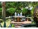 Secluded outdoor dining area with a decorative table and lush garden backdrop at 172 Tradd St, Charleston, SC 29401