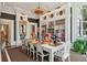 Spacious library with custom built-in bookshelves, a chandelier, and natural light for a cozy atmosphere at 172 Tradd St, Charleston, SC 29401