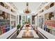 Elegant library with full bookshelves, a chandelier, and large windows creates a warm, inviting atmosphere at 172 Tradd St, Charleston, SC 29401