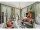 Elegant living room with green walls, patterned curtains, and ornate decor exudes sophisticated charm at 172 Tradd St, Charleston, SC 29401