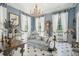 Sophisticated living room features a chandelier, detailed trim work, and large windows at 172 Tradd St, Charleston, SC 29401