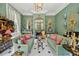 Sophisticated green living room featuring elegant decor, ornate mirrors, and stylish furnishings at 172 Tradd St, Charleston, SC 29401