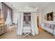 Beautiful main bedroom with four poster bed, patterned wallpaper, and seating, offering a luxurious retreat at 172 Tradd St, Charleston, SC 29401