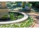 Charming pond with lily pads surrounded by flowering plants and a brick path at 172 Tradd St, Charleston, SC 29401
