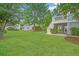 Expansive backyard with lush green grass, mature trees, and a glimpse of a pool, ideal for outdoor activities at 1776 W Canning Dr, Mount Pleasant, SC 29466