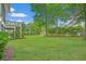Lush backyard featuring mature trees and green grass, offering ample space for outdoor activities and privacy at 1776 W Canning Dr, Mount Pleasant, SC 29466