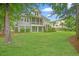 Expansive backyard with lush green lawn and a view of the home's back exterior with a porch at 1776 W Canning Dr, Mount Pleasant, SC 29466