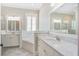 Bright bathroom with double vanities, granite countertops, a soaking tub, and a glass-enclosed shower at 1776 W Canning Dr, Mount Pleasant, SC 29466