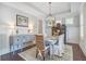 Elegant dining room featuring wainscoting, a decorative chandelier, and a stylish sideboard at 1776 W Canning Dr, Mount Pleasant, SC 29466