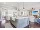 Open-concept kitchen features a large island, stainless steel appliances, and seamless flow into the living area at 1776 W Canning Dr, Mount Pleasant, SC 29466