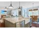 Spacious kitchen featuring a large island with a farmhouse sink, granite countertops, and seamless flow into living area at 1776 W Canning Dr, Mount Pleasant, SC 29466