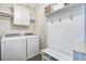 Well-organized laundry room with washer, dryer, and storage options at 1776 W Canning Dr, Mount Pleasant, SC 29466