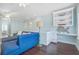 Bright living space with dark floors, blue sofa, and built-in shelving and desk, perfect for cozy relaxation and work at 1776 W Canning Dr, Mount Pleasant, SC 29466