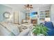 Bright living room with fireplace, built-in shelving and comfortable furniture at 1776 W Canning Dr, Mount Pleasant, SC 29466