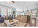 Bright open-concept living room featuring stylish furnishings, hardwood floors, and seamless connection to dining and kitchen at 1776 W Canning Dr, Mount Pleasant, SC 29466