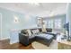 Comfortable upstairs living area with a sectional sofa, accent pillows, and a mounted TV at 1776 W Canning Dr, Mount Pleasant, SC 29466