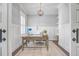 Bright home office with a wooden desk, white shelving, and a stylish light fixture at 1776 W Canning Dr, Mount Pleasant, SC 29466