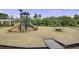 Community playground featuring a variety of play structures, wood chip ground cover, and surrounding trees at 1776 W Canning Dr, Mount Pleasant, SC 29466
