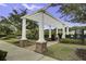 A welcoming entrance to the pool area with white pergola, brick columns and manicured landscaping at 1776 W Canning Dr, Mount Pleasant, SC 29466