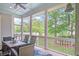 Cozy screened-in porch with comfortable seating overlooking the beautifully landscaped backyard at 1776 W Canning Dr, Mount Pleasant, SC 29466