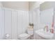 Elegant powder room featuring white paneling, a pedestal sink, and modern fixtures at 1776 W Canning Dr, Mount Pleasant, SC 29466