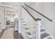 Elegant staircase with dark wood steps, white risers, and wainscoting detail leading to upper level at 1776 W Canning Dr, Mount Pleasant, SC 29466